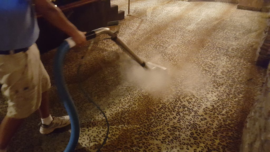 Photo of man cleaning carpet
